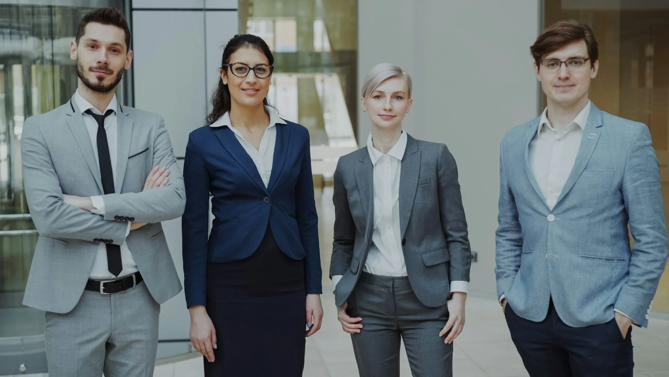 Attorneys and staff standing together in the firm's office